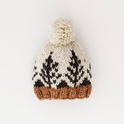 Knitted beanie with a pom-pom on a white background