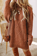 Person wearing a brown cable knit sweater and brown knee-high boots, standing indoors.